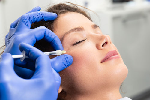 A woman’s face being injected with Botox