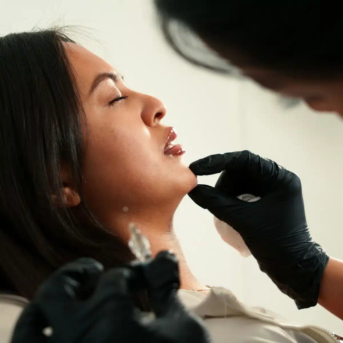 Dermal filler injection along the chin for facial balancing, offered at Cosmetiq Medicine in Vancouver, WA