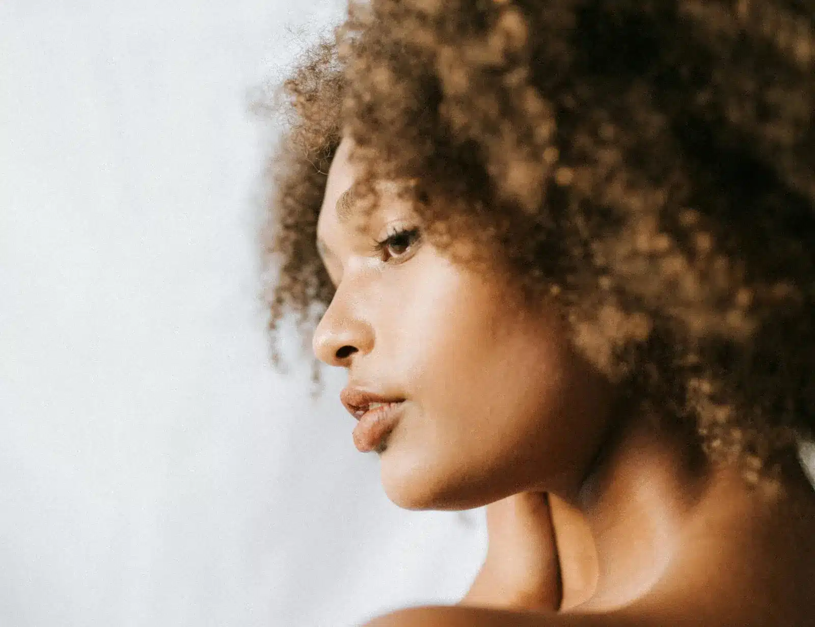 Woman in profile with clear, glowing skin, linking to current Vancouver med spa specials