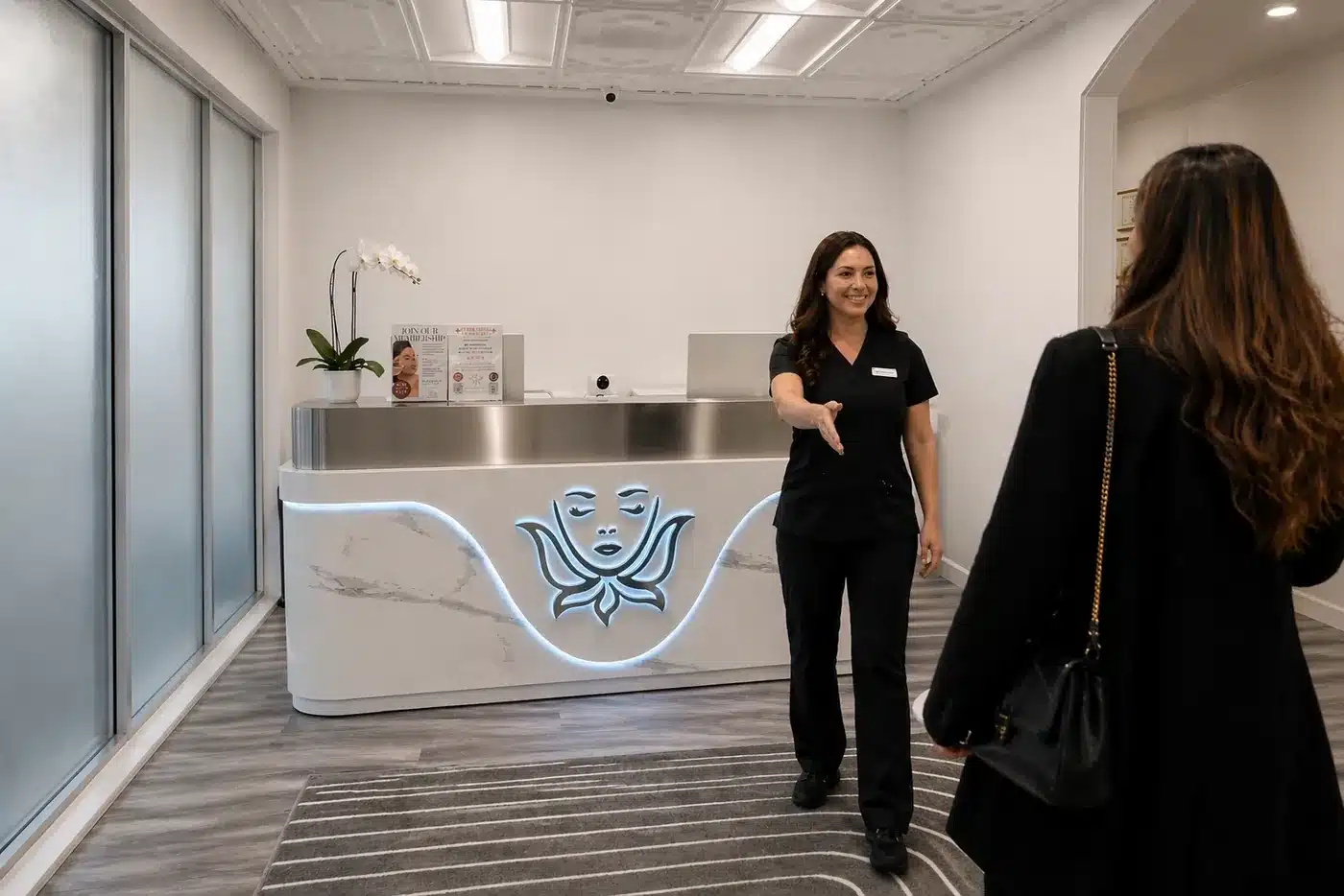 Front desk at Cosmetiq Medicine's Vancouver, WA med spa in Cascade Park, with a team member welcoming a client