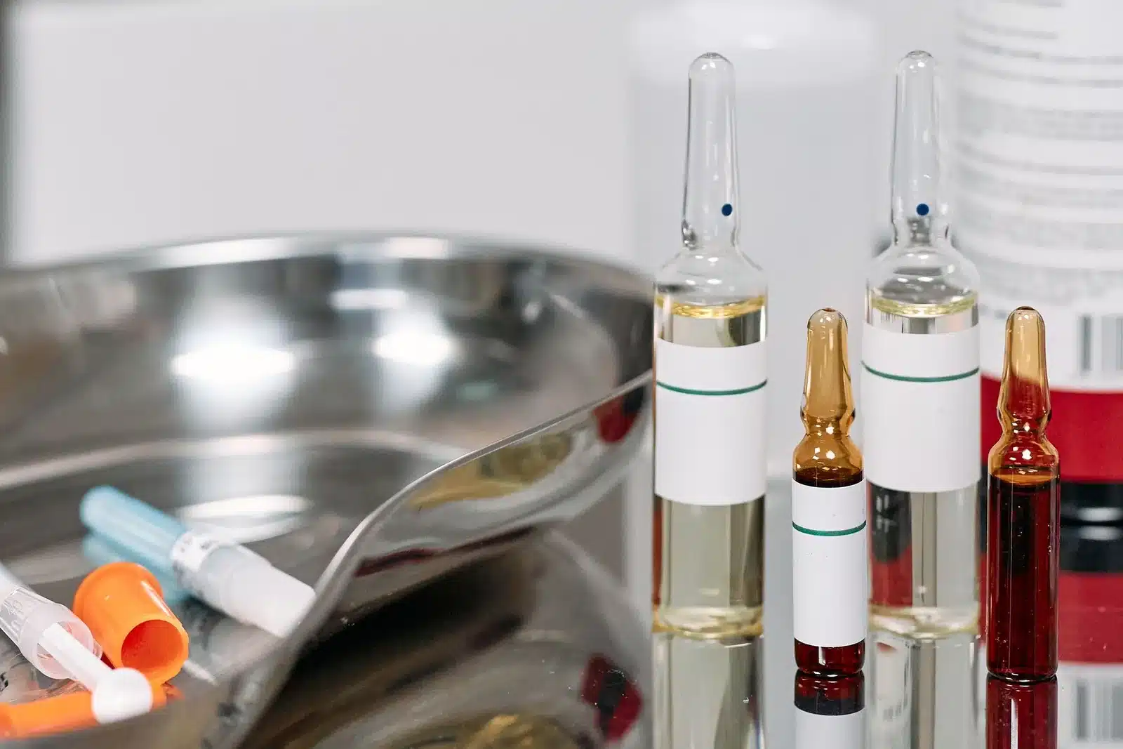 Glass ampoules and vials on a stainless clinic tray, illustrating compounded peptide and wellness injection sourcing questions for Portland, OR and Vancouver, WA patients