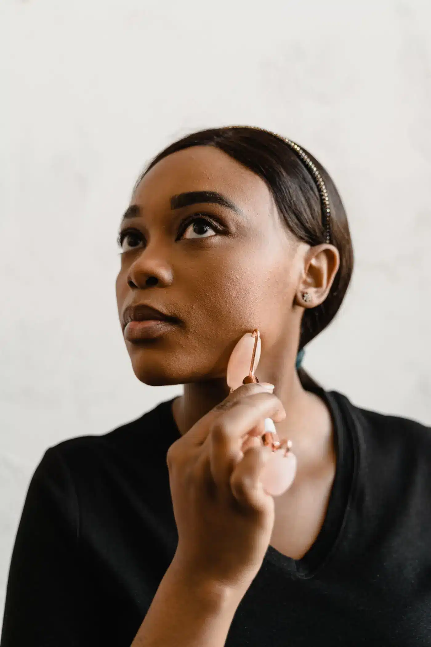 Woman with a defined jawline touching the side of her face