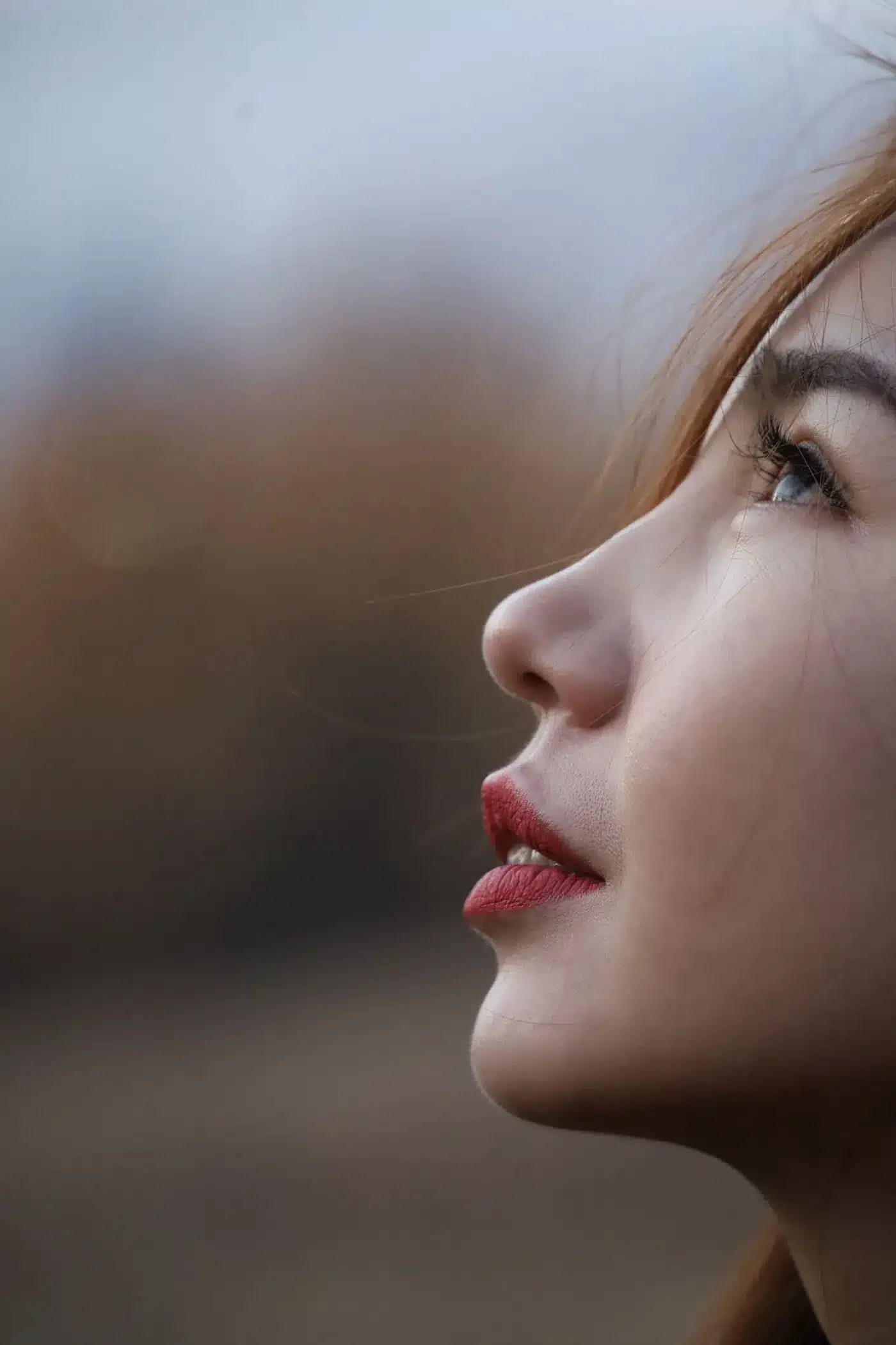 Profile of a woman's chin and neck in soft light