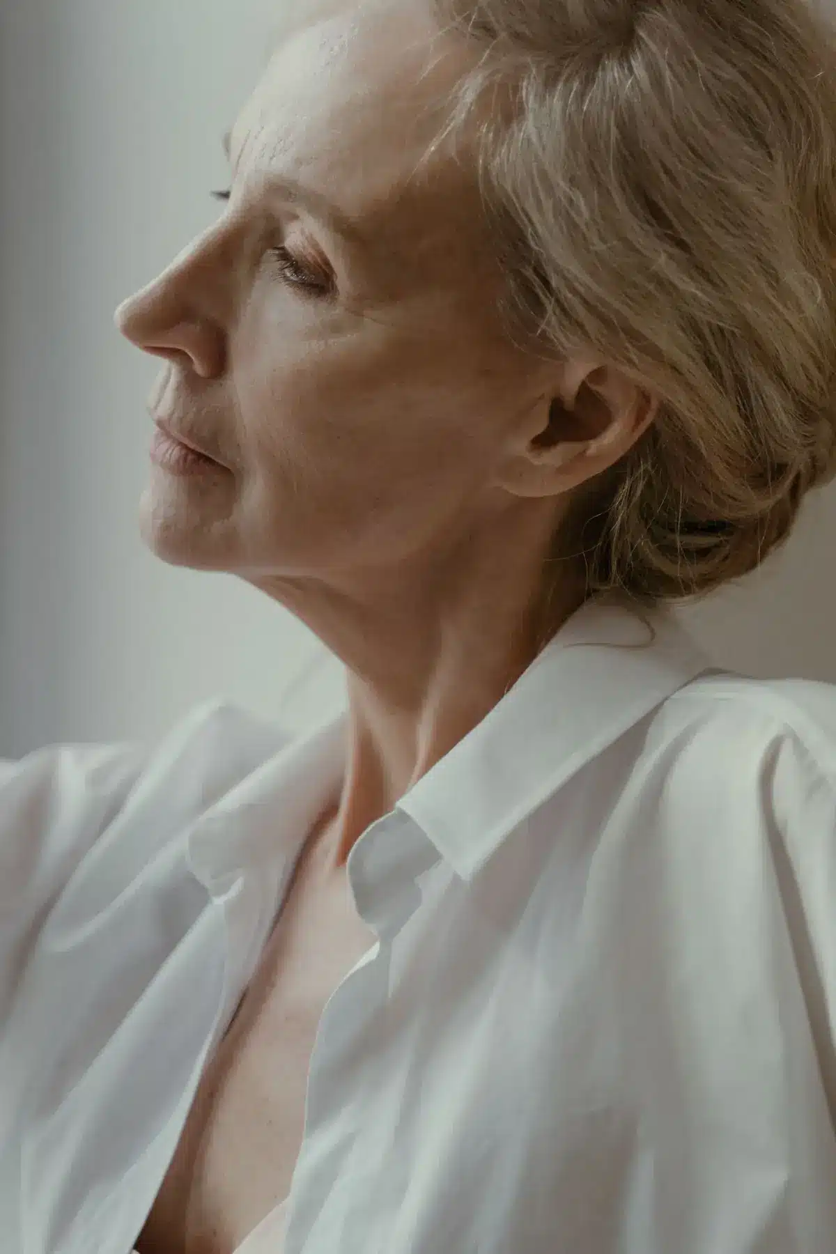 Woman in her fifties in profile with natural, rested-looking skin, Sculptra in Portland, Oregon